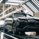 A Lamborghini Urus production line with five cars rolling along it.